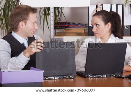 man and woman talking in the office