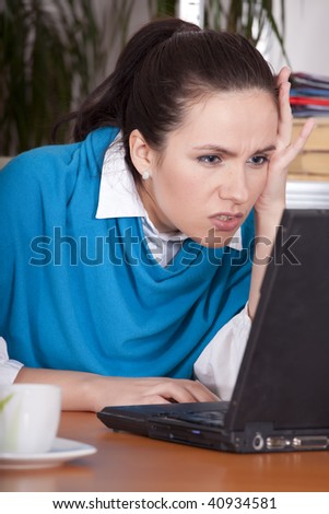 frustrated secretary by the office work at laptop computer