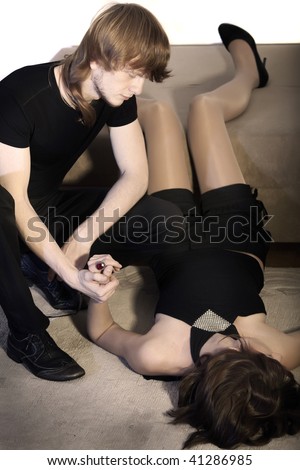 man checking pulse by unconscious woman with sepia effect