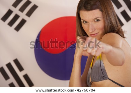beautiful woman in fighting position over the flag of south korea