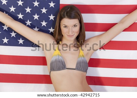 beautiful woman in bikini holding american flag
