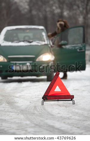 car trouble on the road - warning triangle on foreground