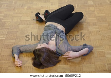 unconscious woman lying on the hardwood  flooring