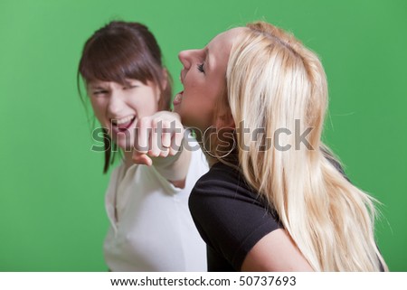 young woman punches another girl to the face