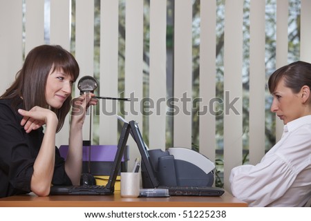 two women in business conversation in the office