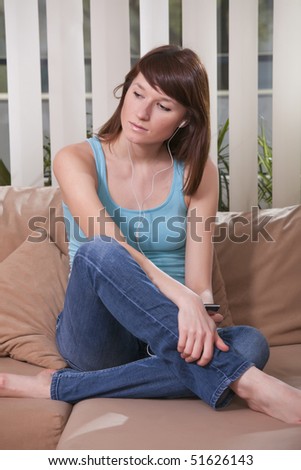 young woman hearing music on the sofa
