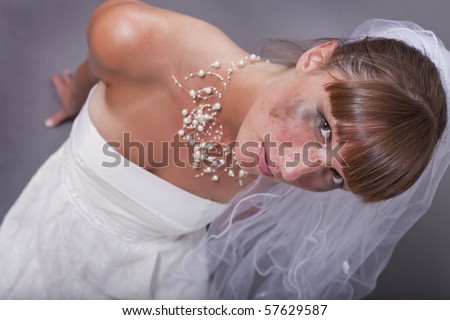 crying and frustrated bride sitting on the ground