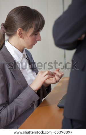 office scene - secretary filing fingernails by the work