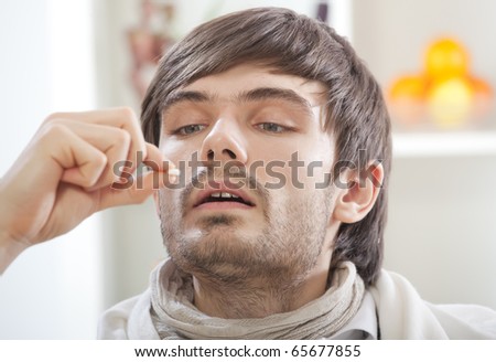 sick man in bed taking vitamin pills