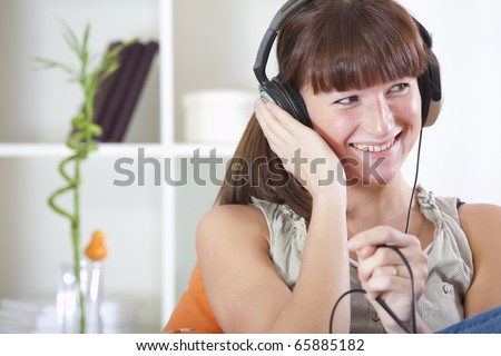 recreation at home - young woman hearing music