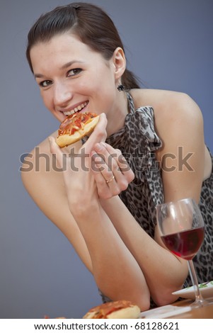 young woman holding a piece of pizza