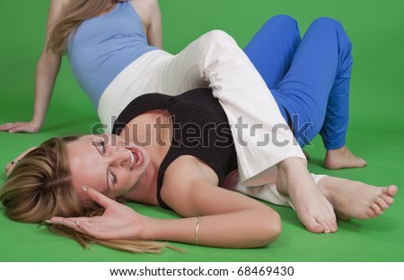 two women fighting on the ground - judo hold