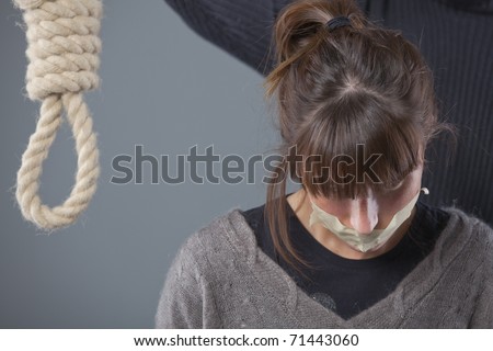 kidnapped and tied up woman and hangman with noose