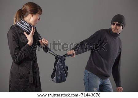 man mugging woman stealing her handbag