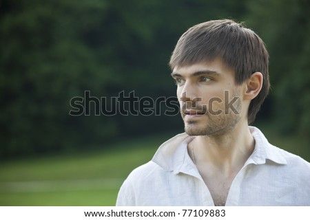 portrait of relaxed man in linen shirt in park