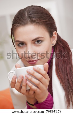 young woman with cup tea relaxed at home