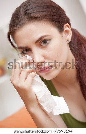 sad crying woman with handkerchief at home