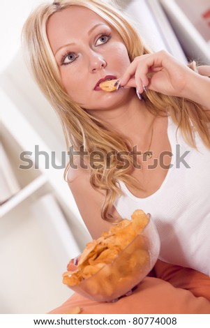 frustrated and unhappy woman eating chips