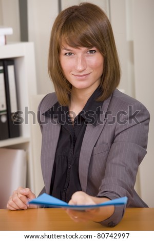 woman in business suit giving job application