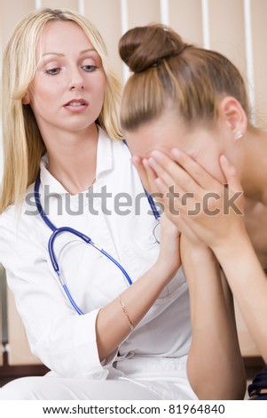 woman doctor and crying patient in her office