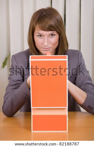 thinking businesswoman with file card holder in office