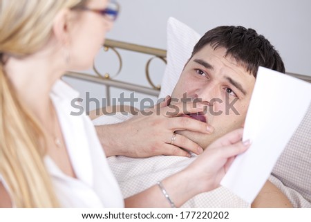 Shocked man on bed after a medicine report