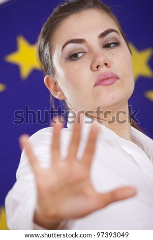 stop hand sign from a woman standing over european flag