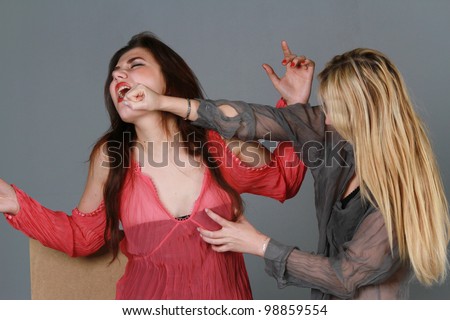 two women fighting - painful face punch