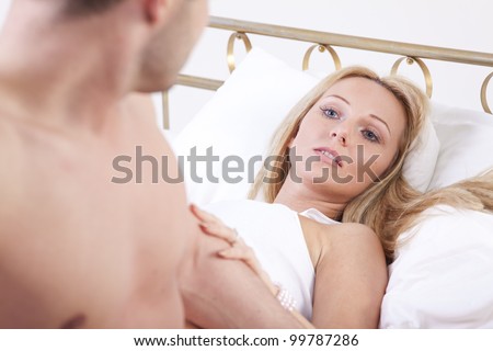 Couple in Love - woman lying on bed looking at her man