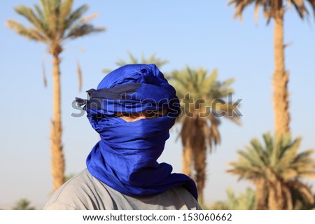 Tourist men with typical nomad head cover - blue turban morocco sahara