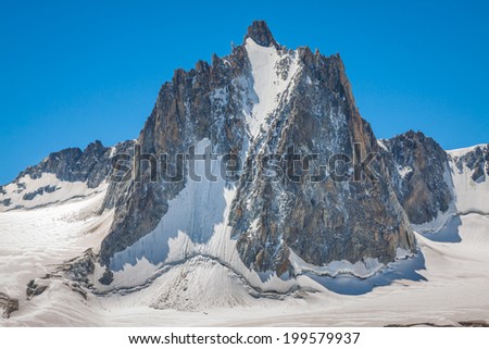 Massif de mont Blanc on the border of France and Italy. In the foreground the ice field and crevasses of the Valley Blanche