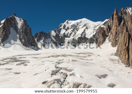 Massif de mont Blanc on the border of France and Italy. In the foreground the ice field and crevasses of the Valley Blanche