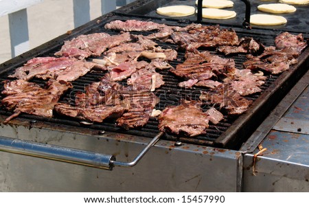Carne asada grilling at a Latin American food festival.