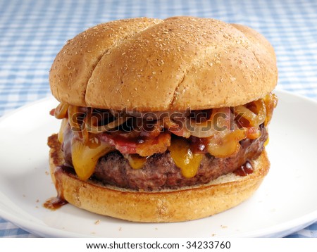 A juicy burger topped with cheddar cheese, bacon, barbecue sauce, and sauteed onions. Served on a toasted wheat bun.