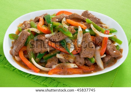 Chinese pepper steak - slices of tender beef stir-fried with red and green bell peppers and onions.