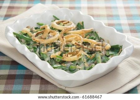 Green bean casserole - a traditional Thanksgiving side dish. Green beans mixed with cream of mushroom soup and topped with french-fried onions.
