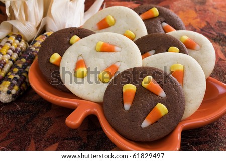 Sugar cookies and chocolate cookies topped with candy corn.
