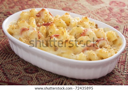 Creamy baked macaroni and cheese with sun-dried tomatoes, provolone cheese, and mozzarella cheese, then topped with bread crumbs.
