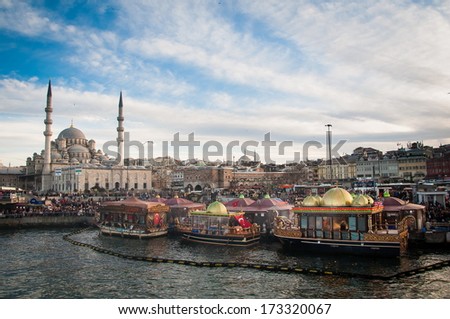 ISTANBUL, TURKEY - FEBRUARY 03, 2013: Fish sandwich shop boats next to a famous mosque of Istanbul.