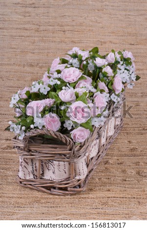Fake pink roses in the basket