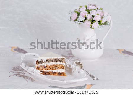 Cake with cream, hazelnuts, dried prunes ( plums ) and poppy seeds