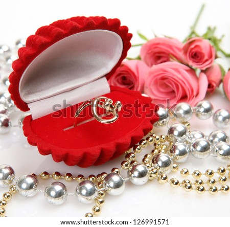 Pink roses and gold ring