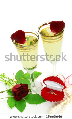 Two glasses filled by a champagne