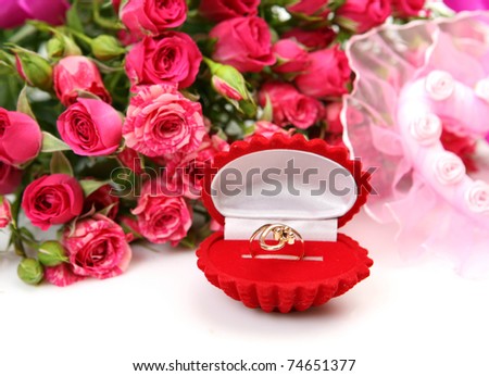 Pink roses and gold ring