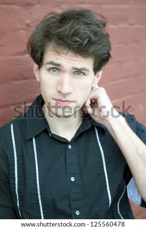 Young Man Scratching his Head