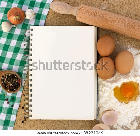 Recipe book with basic ingredients for baking