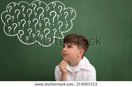 Child thinking with a thought bubble of question marks on the blackboard,  concept for confusion, inspiration and solution