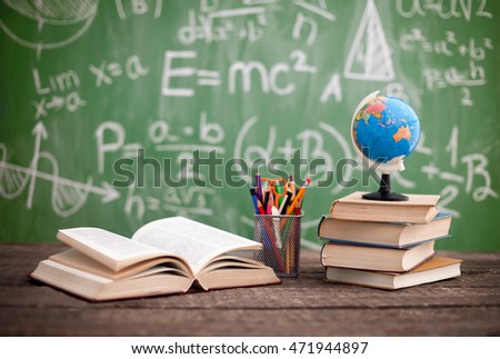 Books with globe on the school desk