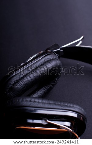 big black headphones close up on black background