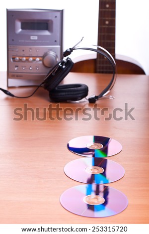 music set with CD disks, headphones, guitar, stereo system on a white background